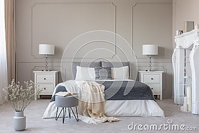 New york style bedroom interior with symmetric design, copy space on empty grey wall Stock Photo