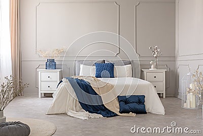 New york style bedroom interior with symmetric design, copy space on empty grey wall Stock Photo