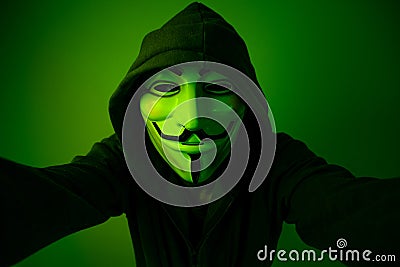 New York, USA - 22 april 2021: man wearing vendetta mask with hoodie on black background. This mask is symbol for Anonymous Editorial Stock Photo