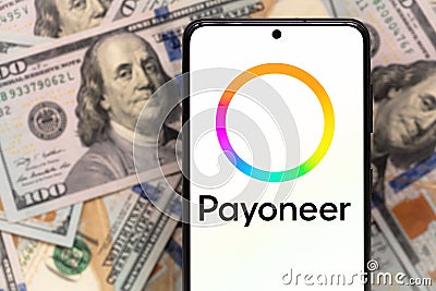 smartphone screen with digital payment service Payoneer mobile application on US dollar banknotes background Editorial Stock Photo