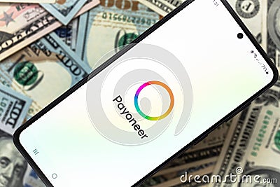 smartphone screen with digital payment service Payoneer mobile application on US dollar banknotes background Editorial Stock Photo