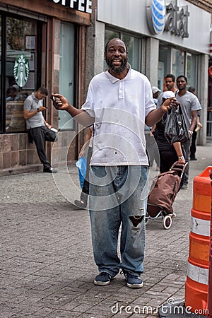 NEW YORK, USA - JUNE 15, 2015 - Homeless smiling for the camera in Harlem on weekday Editorial Stock Photo
