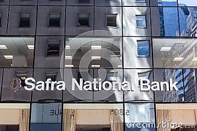 NEW YORK, USA - MAY 15, 2019: The glass windows of the Safra National Bank building reflect the facades of other Editorial Stock Photo