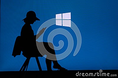 NEW YORK, USA, 25. MAY 2020: Microsoft Windows graphical operating system Young woman silhouette sitting on chair and playing on Editorial Stock Photo