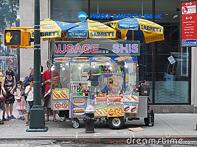 New York, USA. Street food. Fast food cart selling hot dogs and other snack or food in New York City. Food trucks along the town Editorial Stock Photo