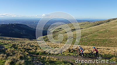 Couple mountain biking across Victoria hills of Christchurch Editorial Stock Photo