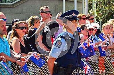 New Zealand police officer woman guarding crowd of people Editorial Stock Photo