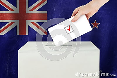 New Zealand Vote concept. Voter hand holding ballot paper for election vote on polling station Stock Photo