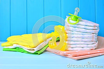 Newborn accessories: diapers, clothes, soother and teether Stock Photo