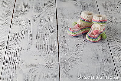 Newborn announcement concept. Knitted booties on aquamarine back Stock Photo