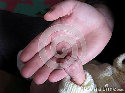 Tiny Fingers Holding Hand Stock Photo