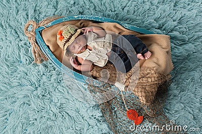 Newborn Baby Boy in Fisherman Outfit Stock Photo