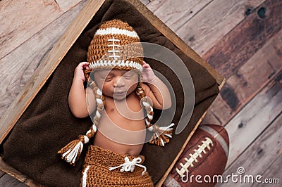 Newborn Baby Boy in Football Costume Stock Photo