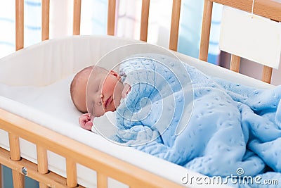 Newborn baby boy in hospital cot Stock Photo