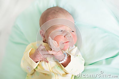 Newborn baby boy in hosptal cot Stock Photo