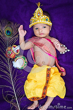 newborn baby boy in krishna dressed with props from unique perspective in different expression Stock Photo