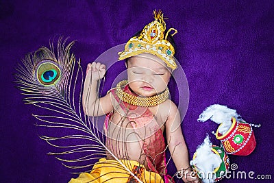 newborn baby boy in krishna dressed with props from unique perspective in different expression Stock Photo