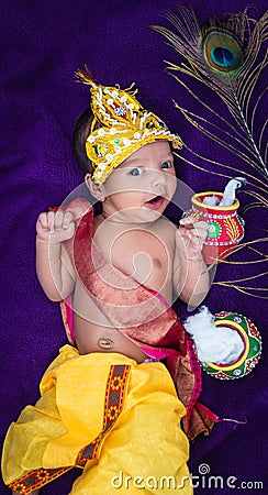newborn baby boy in krishna dressed with props from unique perspective in different expression Stock Photo