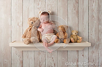 Newborn Baby Boy on a Shelf with Teddy Bears Stock Photo