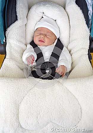 Newborn baby boy sleeping in comfortable car seat Stock Photo