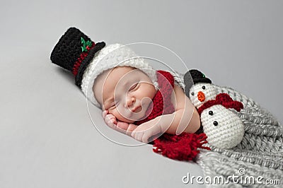 Newborn Baby Boy with Snowman Hat and Plush Toy Stock Photo