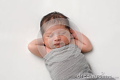 Newborn Baby Boy Swaddled in Gray Wrap Stock Photo