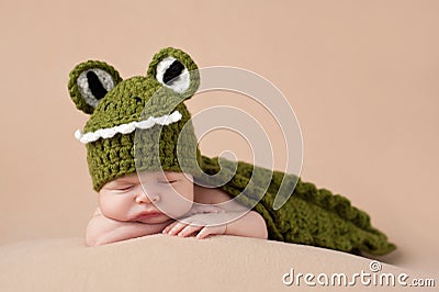 Newborn Baby Boy Wearing an Alligator Costume Stock Photo