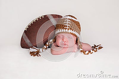Newborn Baby Boy Wearing a Crocheted Football Hat Stock Photo