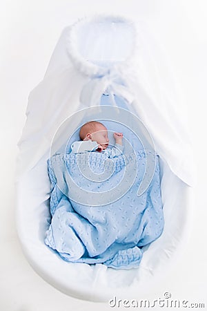 Newborn baby boy in white bassinet Stock Photo