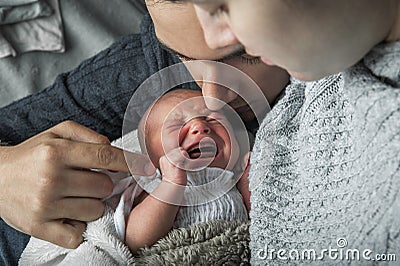 Newborn baby colic close up. Young parents and crying baby 1 month old Stock Photo