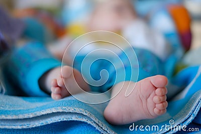 Newborn baby feet on a blue towel Stock Photo