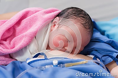 newborn baby girl first drink breastmilk Stock Photo