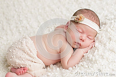 Newborn baby girl in skirt and headband Stock Photo