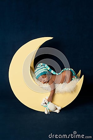 Newborn Baby Girl Sleeping on the Moon Stock Photo