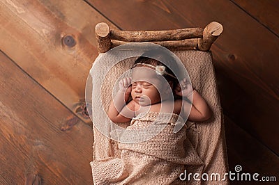 Newborn Baby Girl Sleeping in Tiny Bed Stock Photo