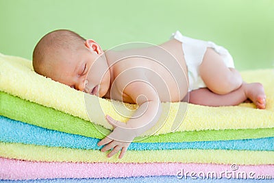 Newborn baby girl sleeping on towels Stock Photo
