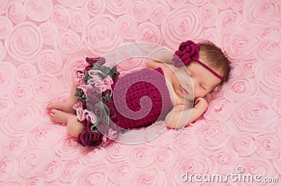 Newborn Baby Girl Wearing a Crocheted Romper Stock Photo