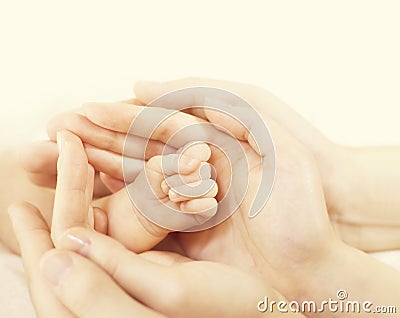 Newborn Baby Hand in Family Hands, Parents Hold Protect New Born Stock Photo