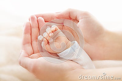 Newborn baby hand in mother hands. Help asistance concept Stock Photo