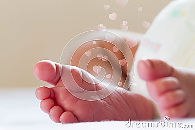Newborn baby infant feet on white bed Stock Photo