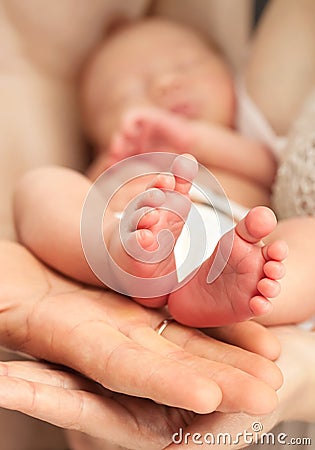 Newborn baby in mother's arms Stock Photo