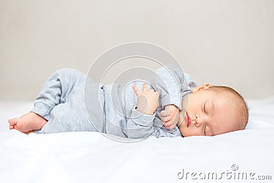 A newborn baby is sleeping on a blanket Stock Photo