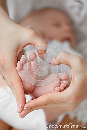 Newborn baby sleeping on mother's hands. Stock Photo