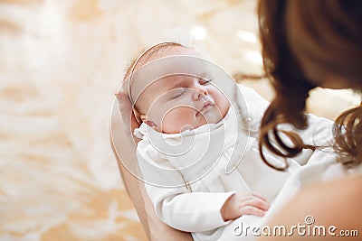 Newborn baby sleeping on mother's hands. Stock Photo