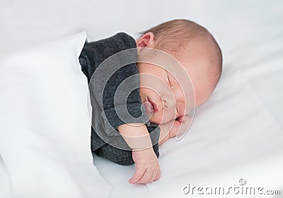 Newborn Baby sleeping peacefully in Ñrib Stock Photo