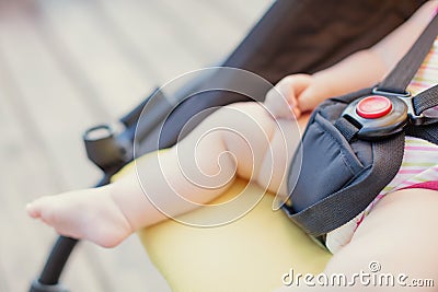 Newborn baby sleeping in stroller outdoors. Small baby barefoot with copy space Stock Photo