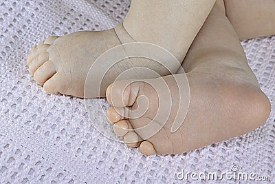 Newborn baby small feet on blanket, cute toes closeup Stock Photo