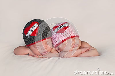 Newborn Baby Twins in Love Mom and Dad Hats Stock Photo