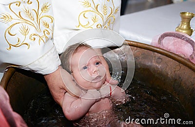 Newborn baby water baptism Stock Photo