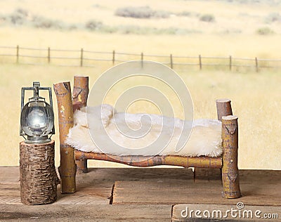 Newborn backdrop prop log bed with faux bedspread. Stock Photo